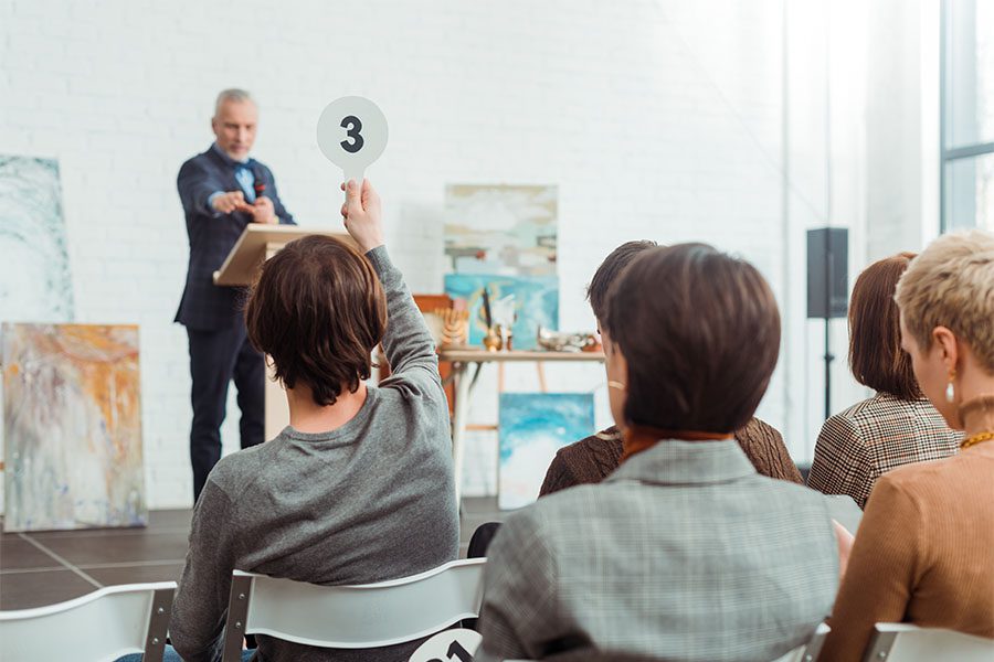 Auctioneer Liability Insurance - View of a Group of People Participating in an Art Live Auction