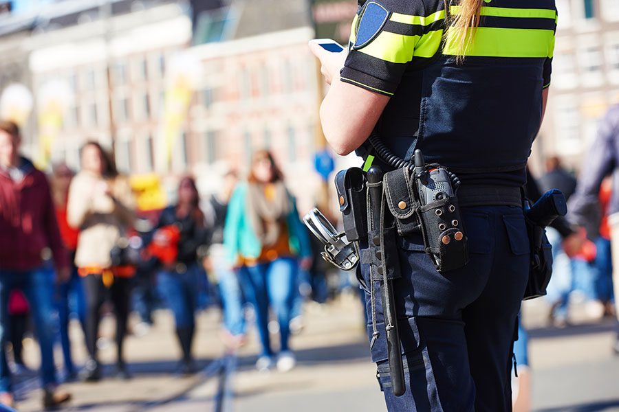 Constable Bonds - Closeup View of a Female Police Officer Patrolling a Busy City Street